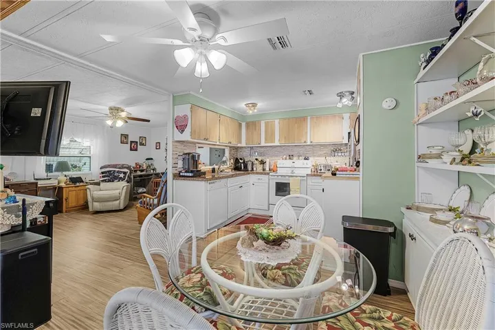 Dining space featuring visible vents, a ceiling fan, and light wood finished floors