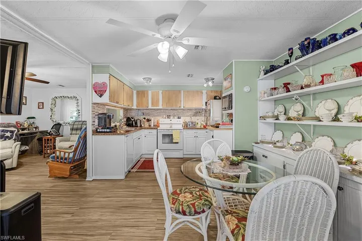 Dining room with light wood-type flooring and a ceiling fan