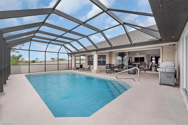 Pool featuring grilling area, a patio area, and a lanai