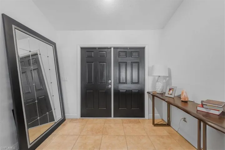 Foyer featuring baseboards and light tile patterned flooring
