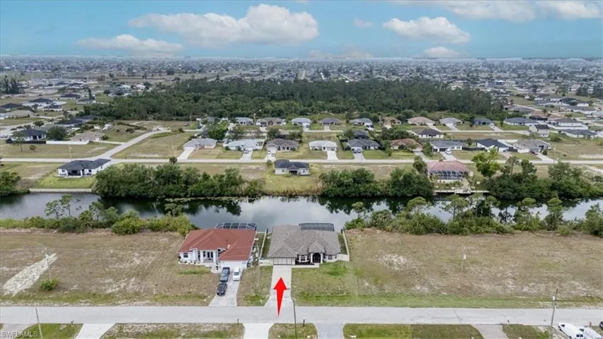 Drone / aerial view with a residential view and a water view
