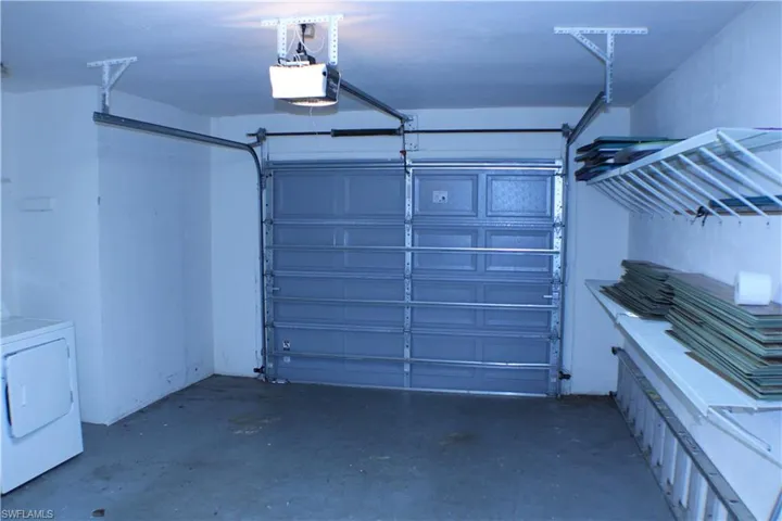 Garage featuring a garage door opener and washer / clothes dryer