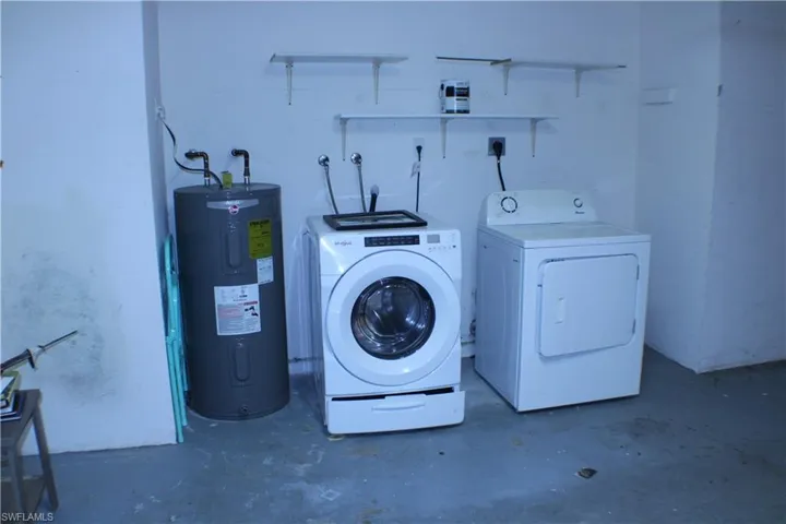 Washroom with separate washer and dryer and electric water heater