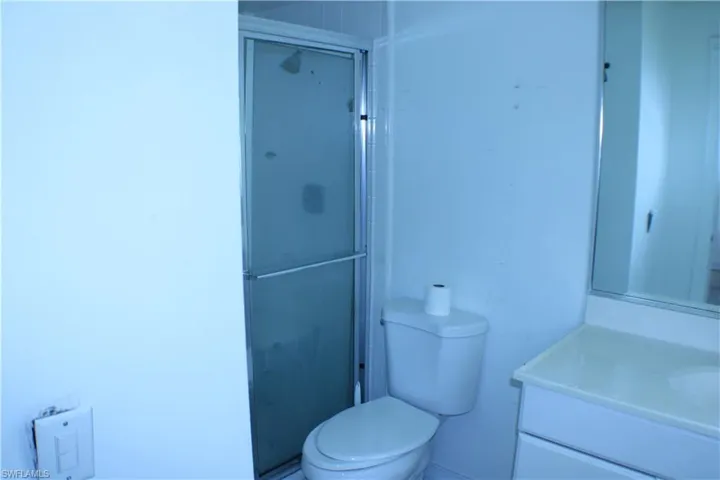Bathroom with vanity, toilet, and walk in shower