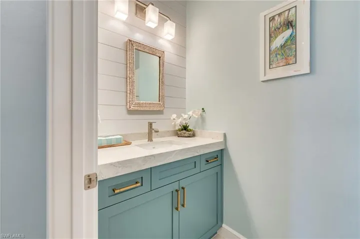 Bathroom featuring vanity and wood walls