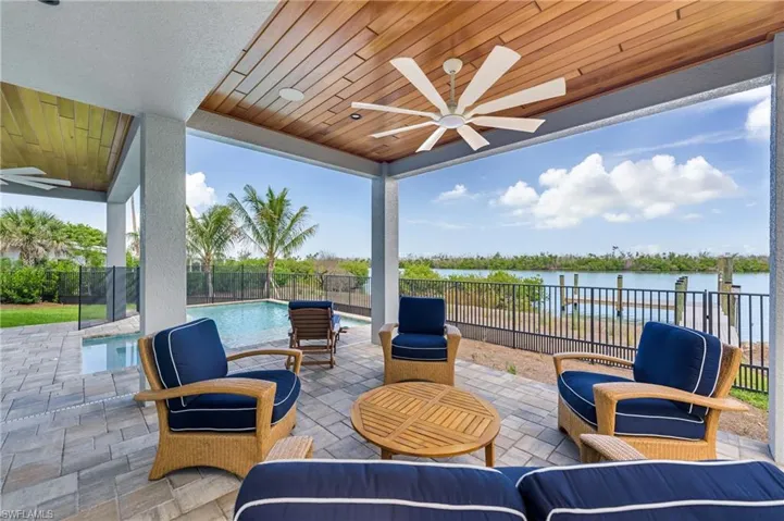 Fenced backyard with a ceiling fan and a patio area