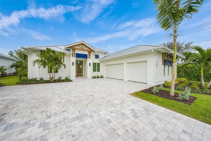 This image is of a Palm plan completed a few doors down from 4560 Seagrove Landing Way. This reflects the plan, construction, and overall style planned for 4560 Seagrove Landing Way. Shutter colors, wood accents, and driveway color may vary based on Buyer preference.