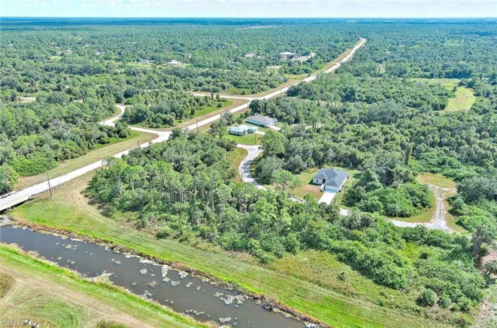 Aerial view of property's location featuring a nearby body of water