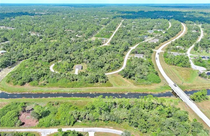 Aerial overview of property's location featuring a forest