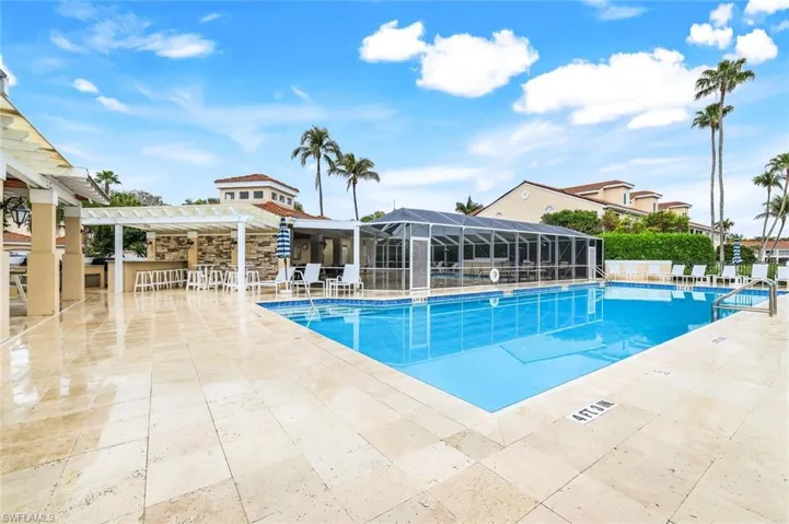 Pool featuring a patio, fence, a bar, and a pergola
