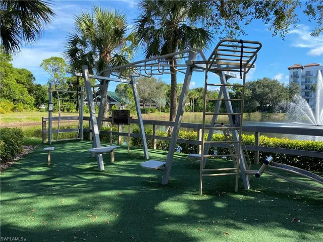 View of jungle gym with a water view