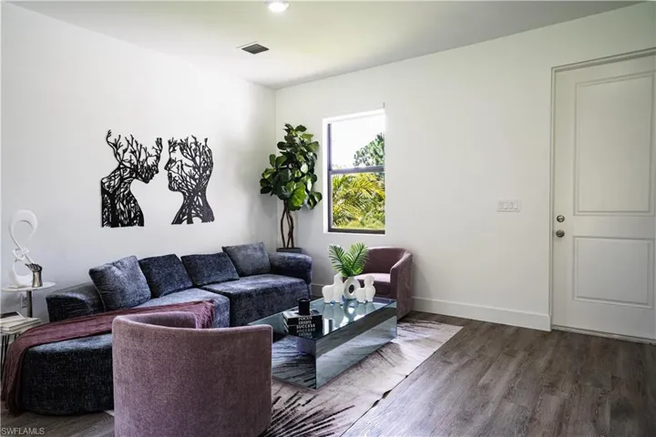 Living room featuring wood finished floors and baseboards