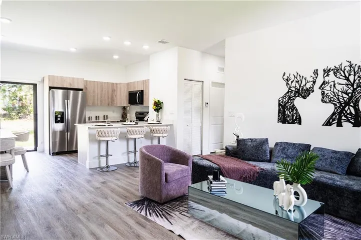 Living area featuring light wood finished floors and recessed lighting