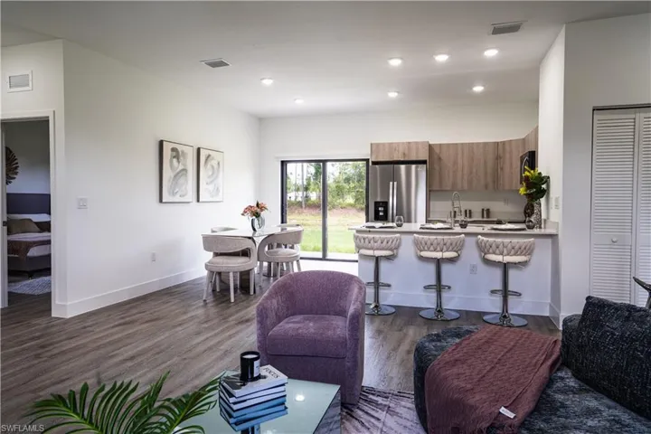 Living room with dark wood-style flooring and recessed lighting