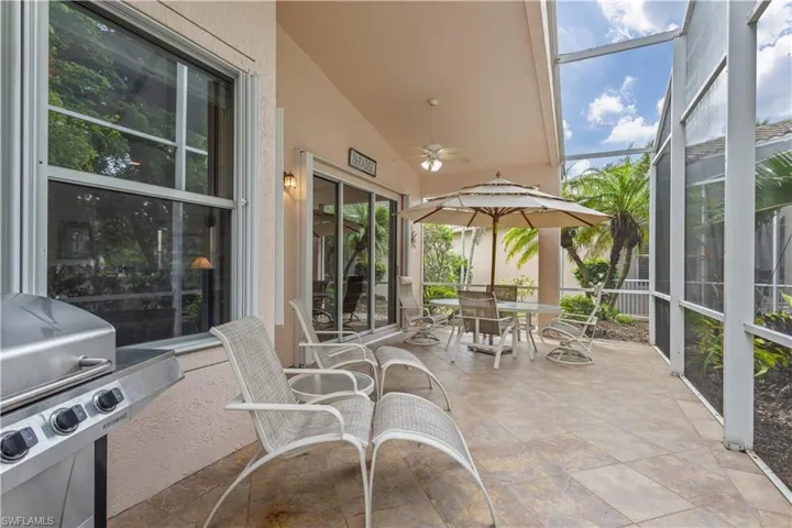 View of patio / terrace with a water view, a sunroom, and a lanai