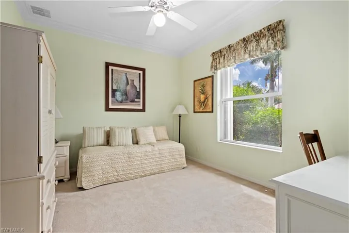 Bedroom featuring ornamental molding, a closet, light carpet, and ceiling fan