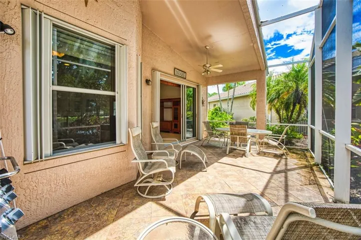 Sunroom featuring ceiling fan, outdoor dining space, and lofted ceiling