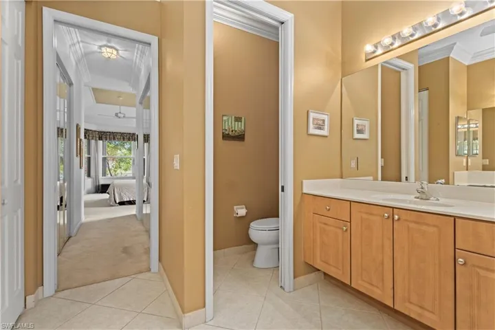 Office area featuring light carpet, ornamental molding, and a ceiling fan