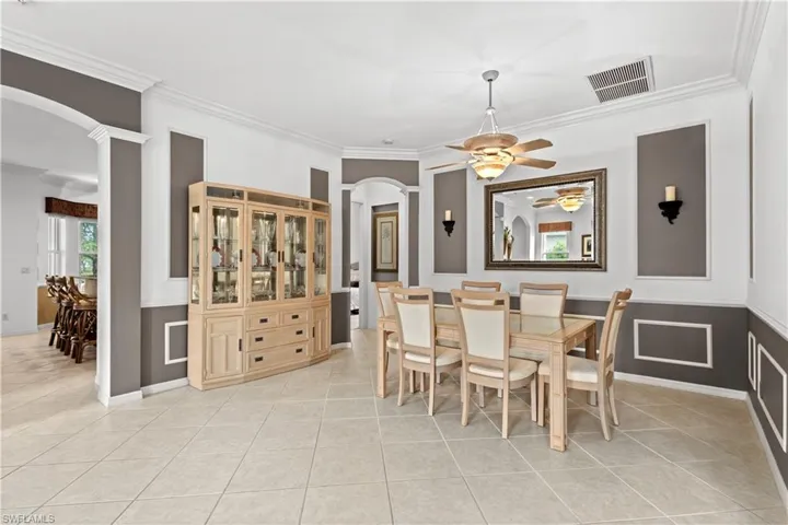 Living room featuring light tile patterned floors, ornamental molding, and recessed lighting