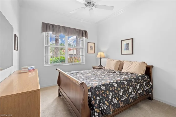 Living area featuring a ceiling fan, ornamental molding, arched walkways, light tile patterned floors, and recessed lighting