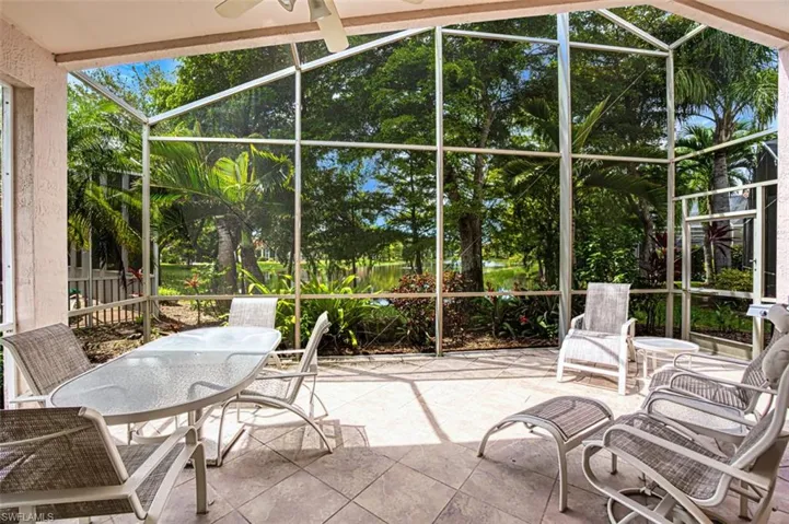 Sunroom / solarium with a ceiling fan, outdoor dining space, and a patio