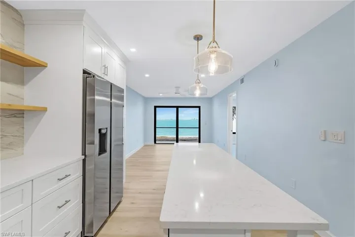 Welcome to easy island living from this beautifully remodeled first-floor bayfront condo.