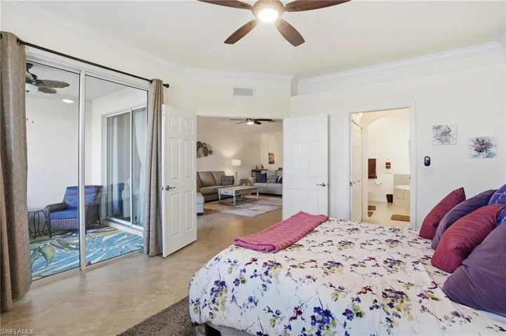 Bedroom with crown molding, ensuite bathroom, and a ceiling fan