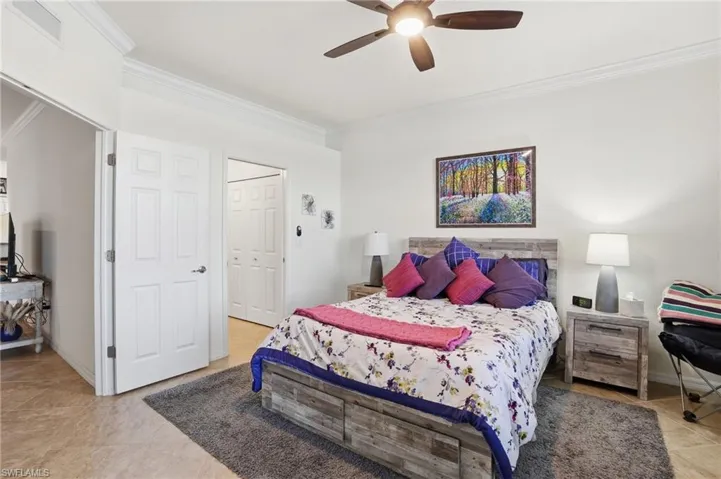 Bedroom with crown molding, a ceiling fan, and a closet