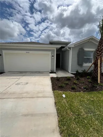 Light gray siding exterior with a white garage door