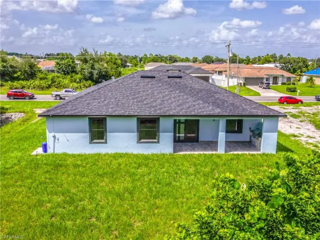 Rear view of property featuring a lawn