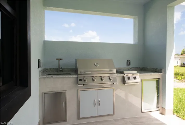 View of patio / terrace featuring area for grilling and sink