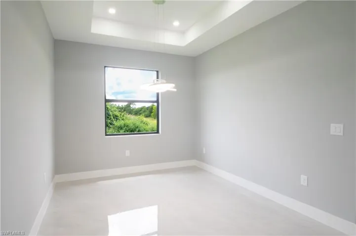 Spare room with a raised ceiling