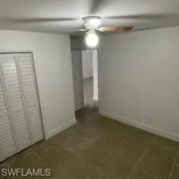 Unfurnished bedroom with a closet and a ceiling fan