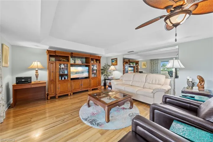 Living room with light wood-type flooring and ceiling fan
