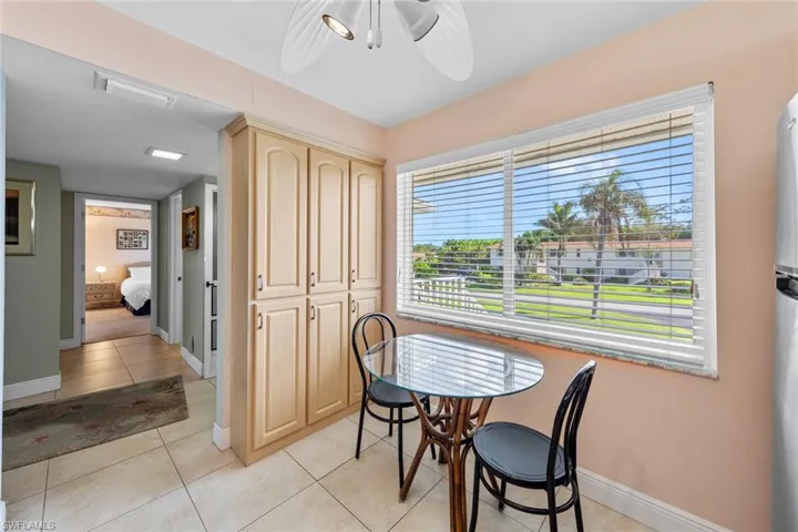 Dining area featuring light tile patterned floors and ceiling fan
