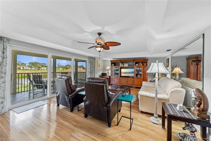 Living room featuring light wood-type flooring and ceiling fan