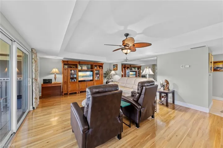 Living room featuring ceiling fan and light hardwood / wood-style floors