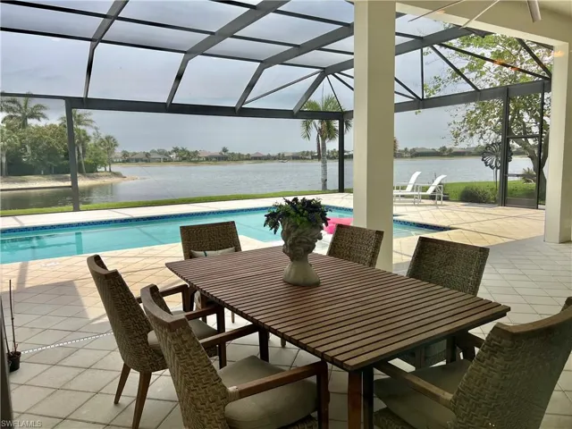 The lanai featuring a pool, spa, outdoor kitchen, & dining.