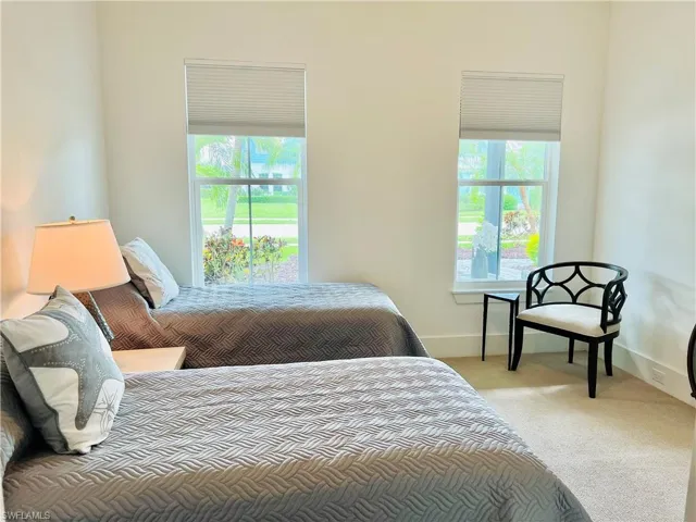 Guest bedroom featuring multiple windows