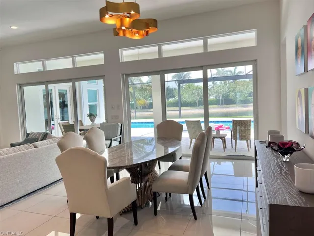 Dining space featuring trendy chandelier plus pool & lake views!