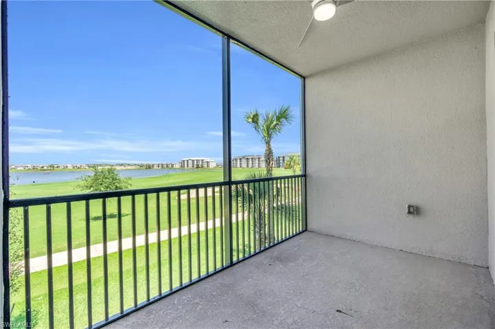 Unfurnished sunroom featuring a water view and ceiling fan