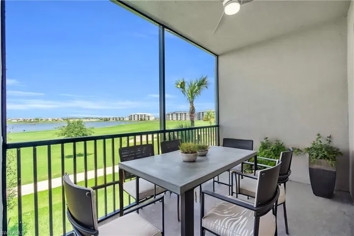 Sunroom / solarium with a water view and ceiling fan