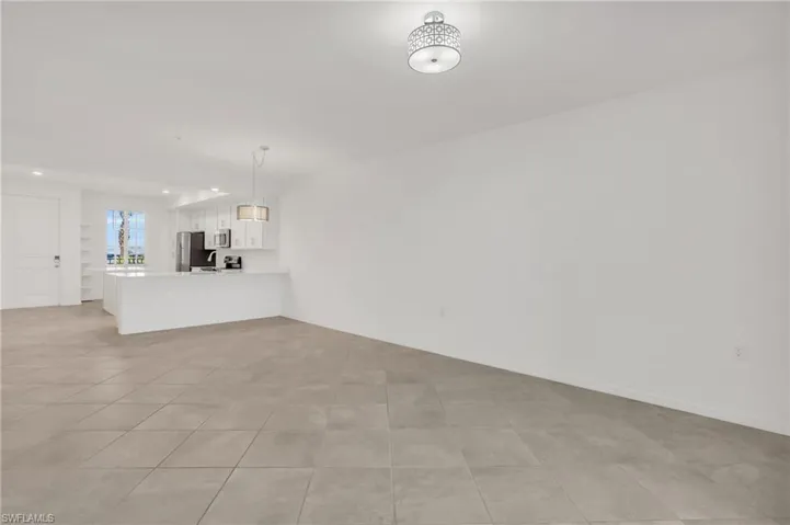 Unfurnished living room featuring light tile patterned flooring