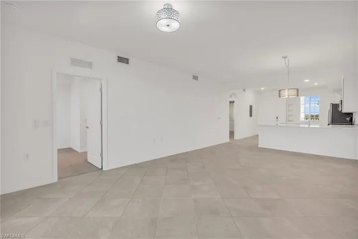 Unfurnished living room with light tile patterned floors