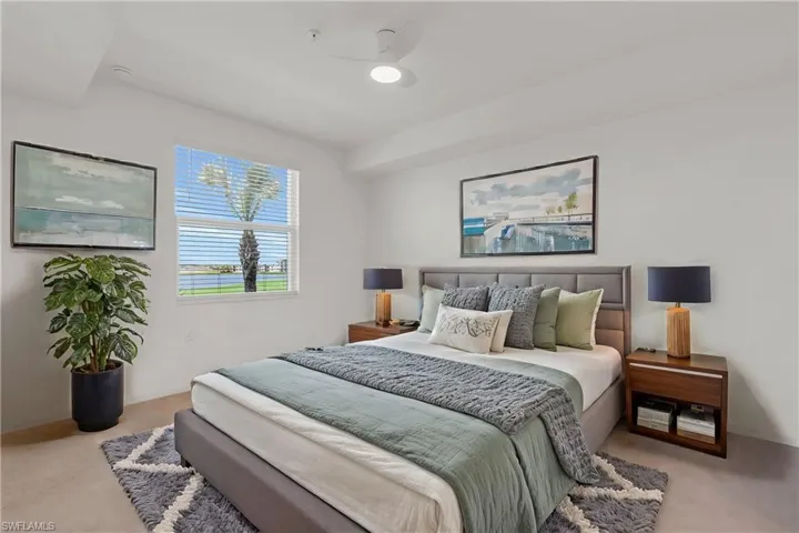 Bedroom featuring ceiling fan and light colored carpet