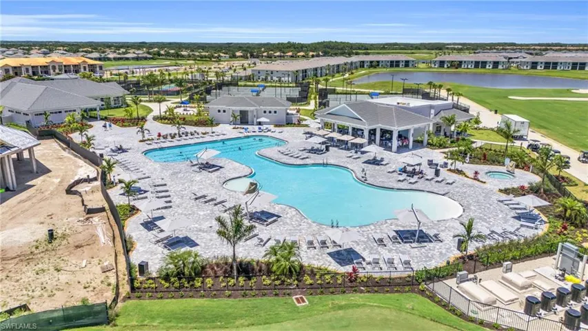 View of swimming pool with a water view, a patio area, and a yard