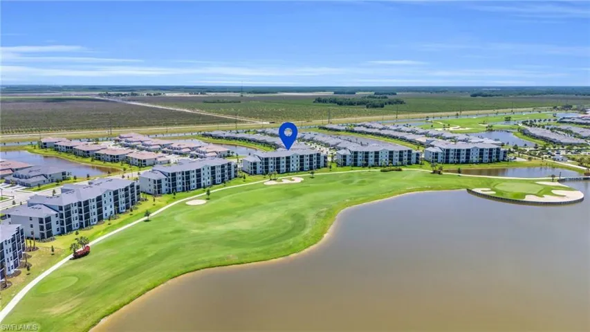 Birds eye view of property with a water view