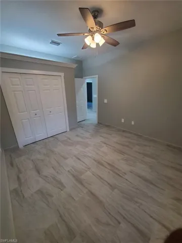 Spare room featuring tile flooring and ceiling fan