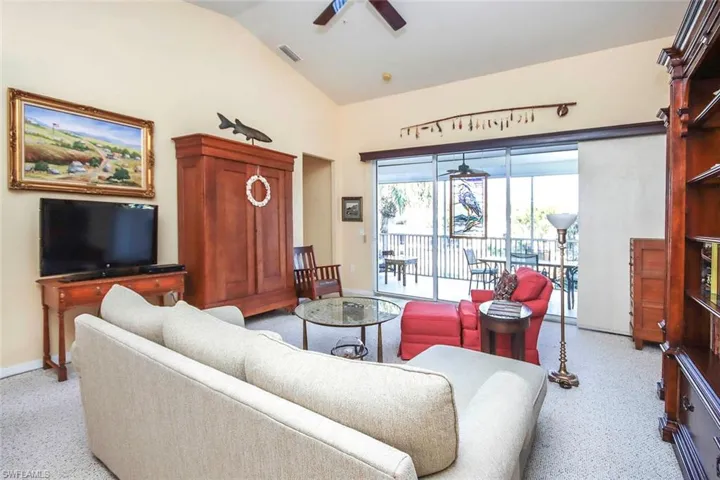 Living area featuring ceiling fan and vaulted ceiling