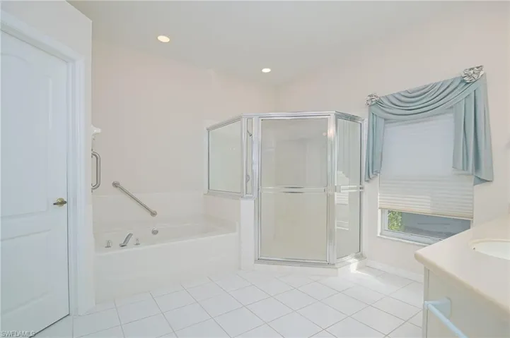 Spacious Primary Bathroom with Large Shower, Dual Sinks, and Separate Jetted-Tub